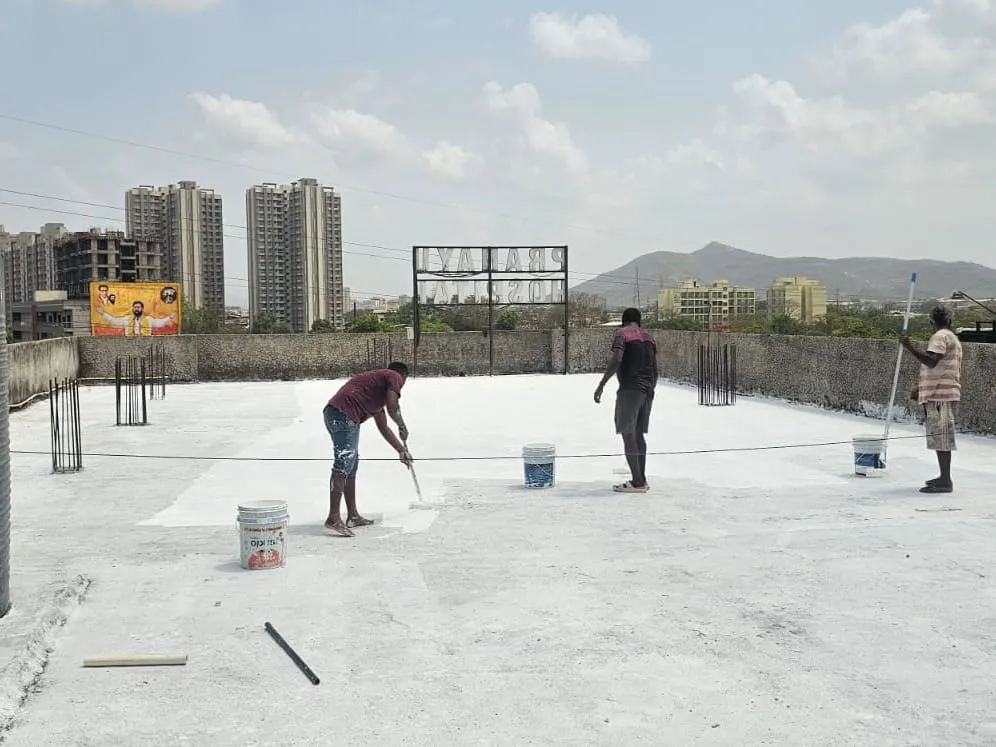 Waterproofing coating being rolled across a prepared terrace — Mahadev Waterproofing