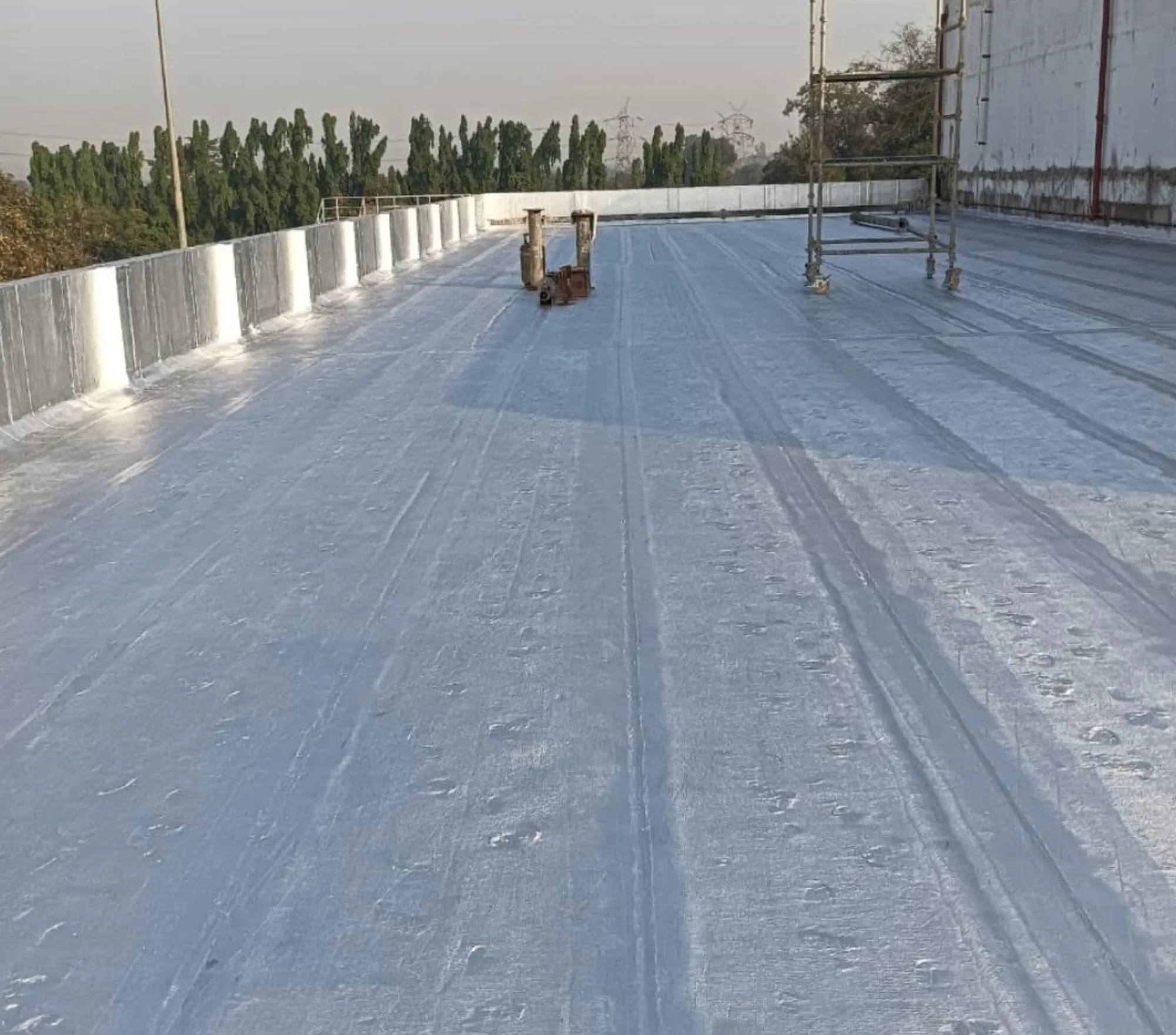 Bituminous membrane being torch-applied on a terrace in Thane — Mahadev Waterproofing